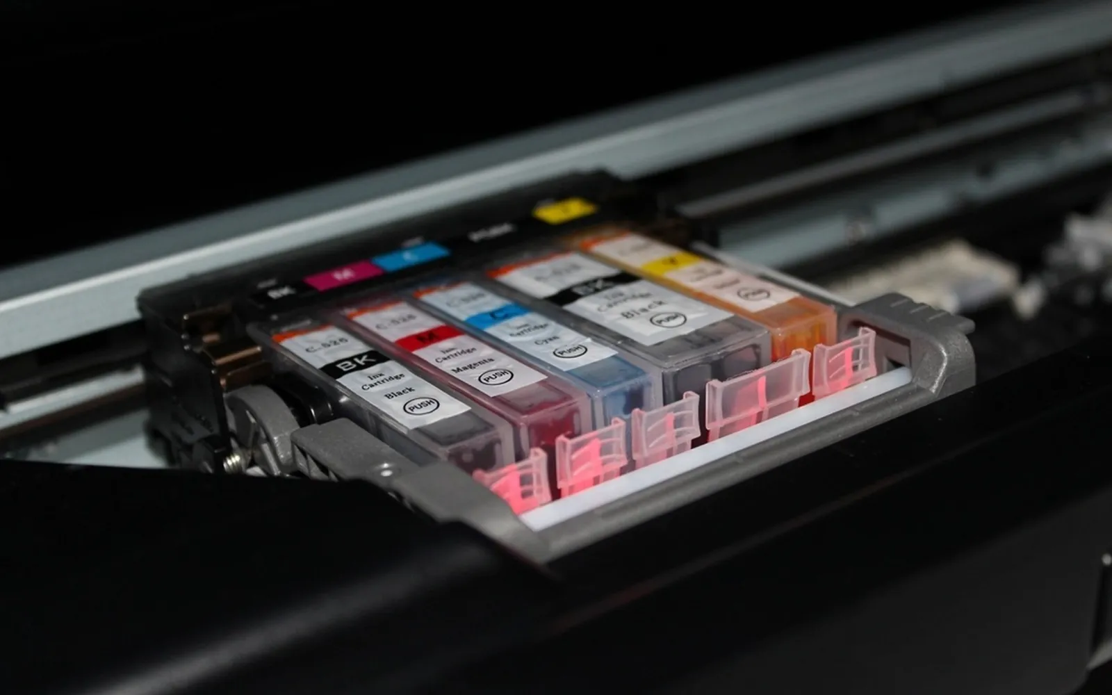 Colour ink cartridges seated in the carriage of an inkjet printer