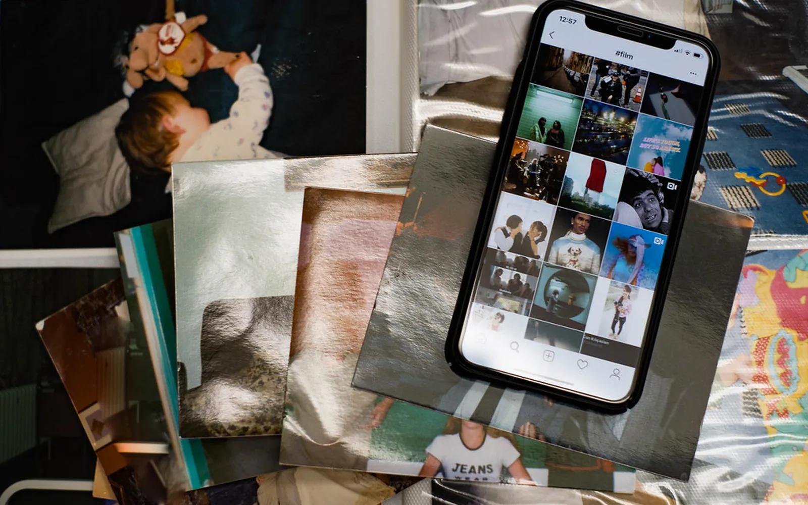Printed photos laid out next to a smartphone on a table
