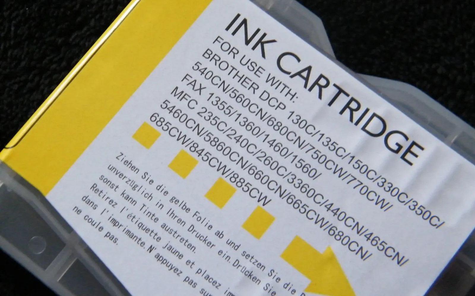 Close-up of a yellow inkjet cartridge with its printed label